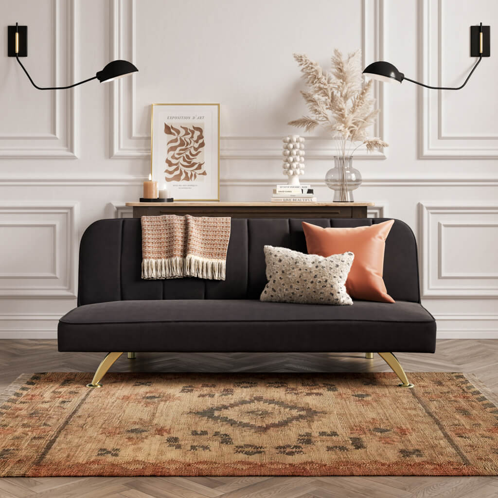 LPD Furniture Burlington black velvet sofa bed with brushed gold legs in a modern living room setting