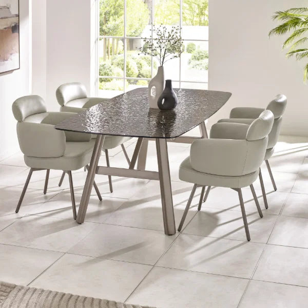 Callisto smoked bubble glass dining table with brushed bronze legs in a modern dining room setting