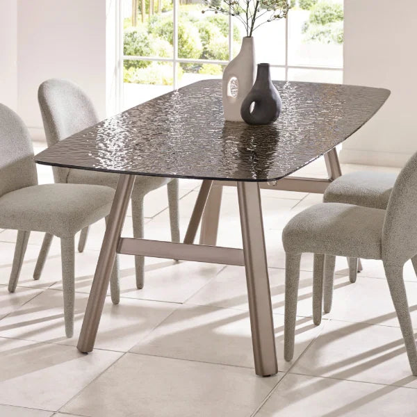 Callisto smoked bubble glass dining table with brushed bronze legs in a modern dining room setting