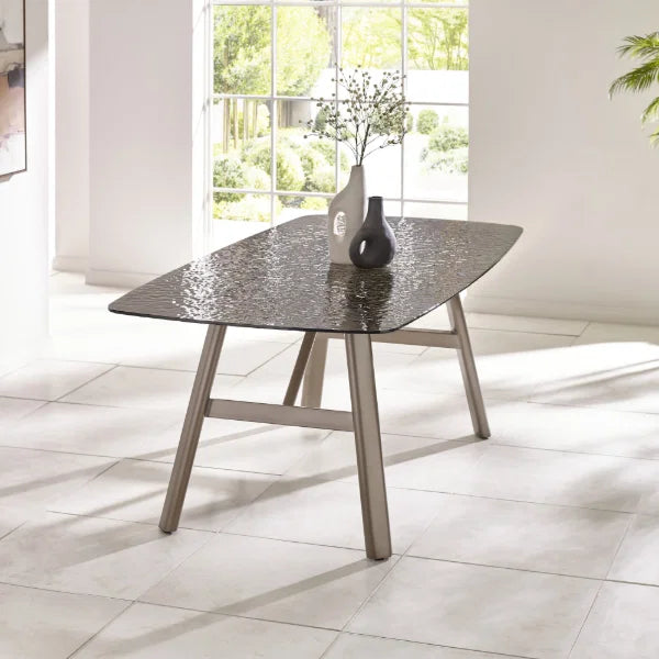 Callisto smoked bubble glass dining table with brushed bronze legs in a modern dining room setting