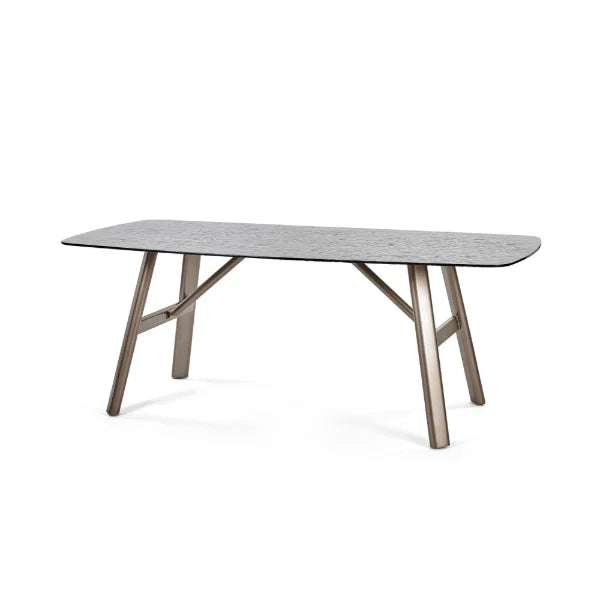 Callisto smoked bubble glass dining table with brushed bronze legs in a modern dining room setting