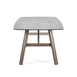 Callisto smoked bubble glass dining table with brushed bronze legs in a modern dining room setting