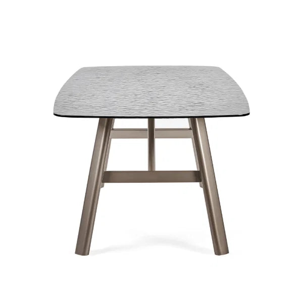 Callisto smoked bubble glass dining table with brushed bronze legs in a modern dining room setting
