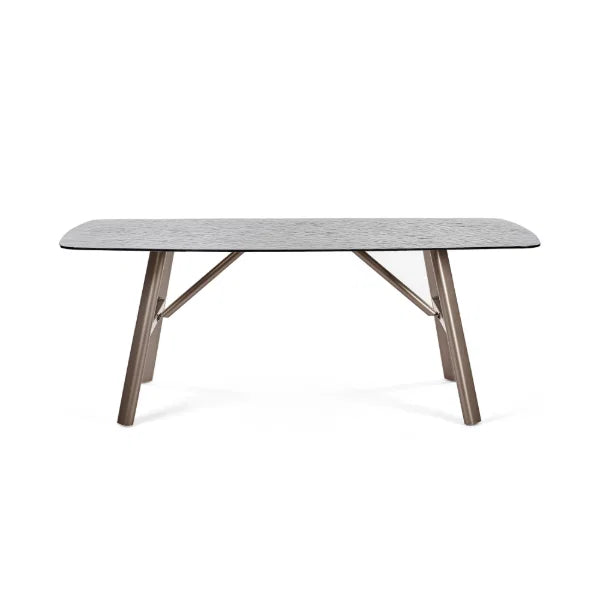 Callisto smoked bubble glass dining table with brushed bronze legs in a modern dining room setting