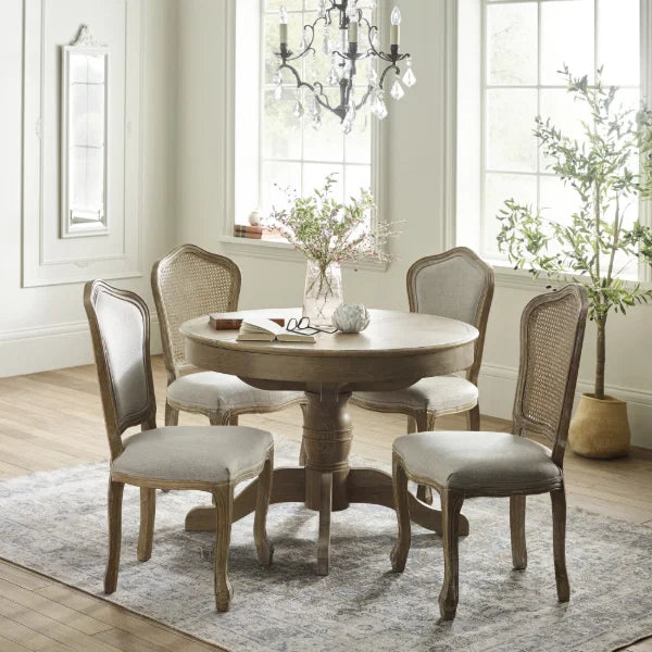 Camille set of 2 rattan dining chairs with handwoven backrest and beige linen seats in a modern dining room