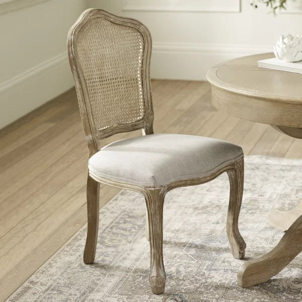Camille set of 2 rattan dining chairs with handwoven backrest and beige linen seats in a modern dining room