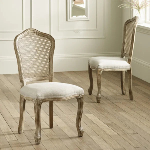 Camille set of 2 rattan dining chairs with handwoven backrest and beige linen seats in a modern dining room
