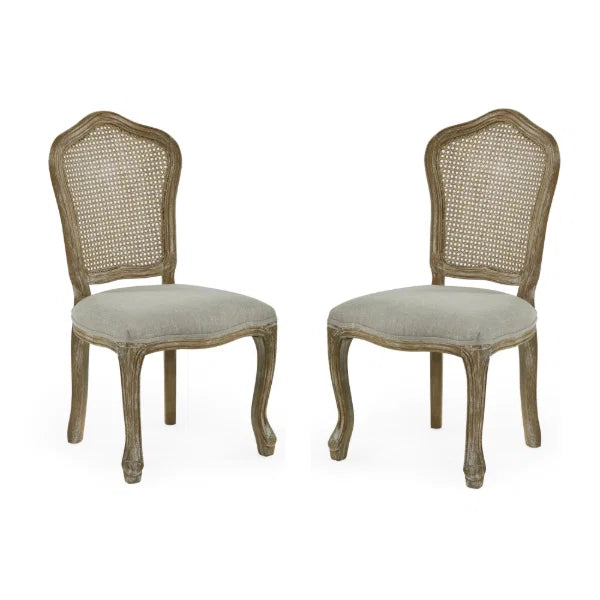 Camille set of 2 rattan dining chairs with handwoven backrest and beige linen seats in a modern dining room