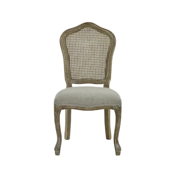 Camille set of 2 rattan dining chairs with handwoven backrest and beige linen seats in a modern dining room