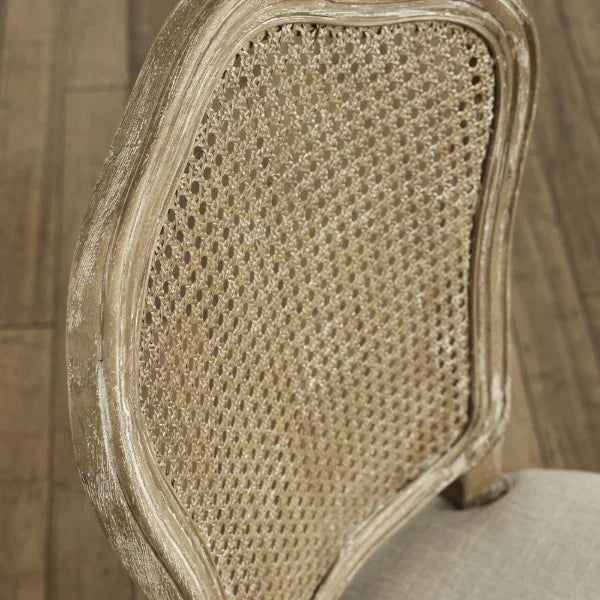 Camille set of 2 rattan dining chairs with handwoven backrest and beige linen seats in a modern dining room