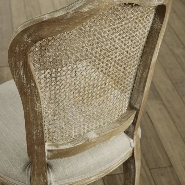 Camille set of 2 rattan dining chairs with handwoven backrest and beige linen seats in a modern dining room
