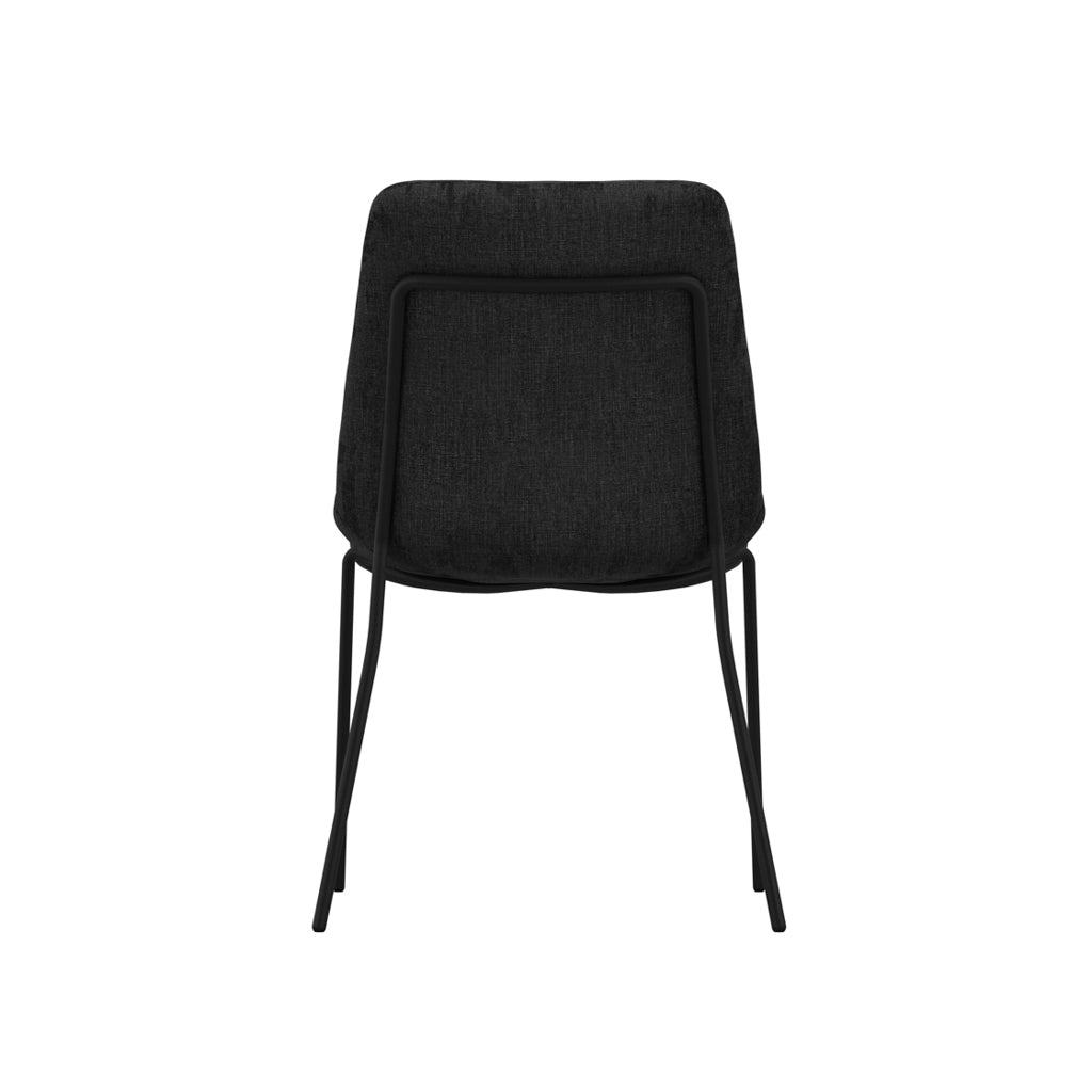 LPD Furniture Carlo black textured velvet dining chair with curved metal back in a modern dining setting
