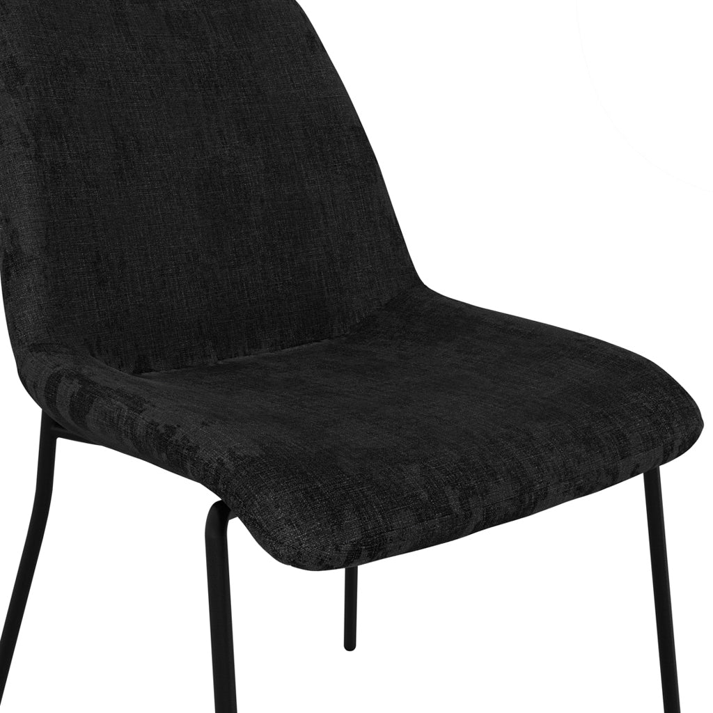 LPD Furniture Carlo black textured velvet dining chair with curved metal back in a modern dining setting