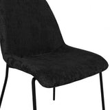 LPD Furniture Carlo black textured velvet dining chair with curved metal back in a modern dining setting