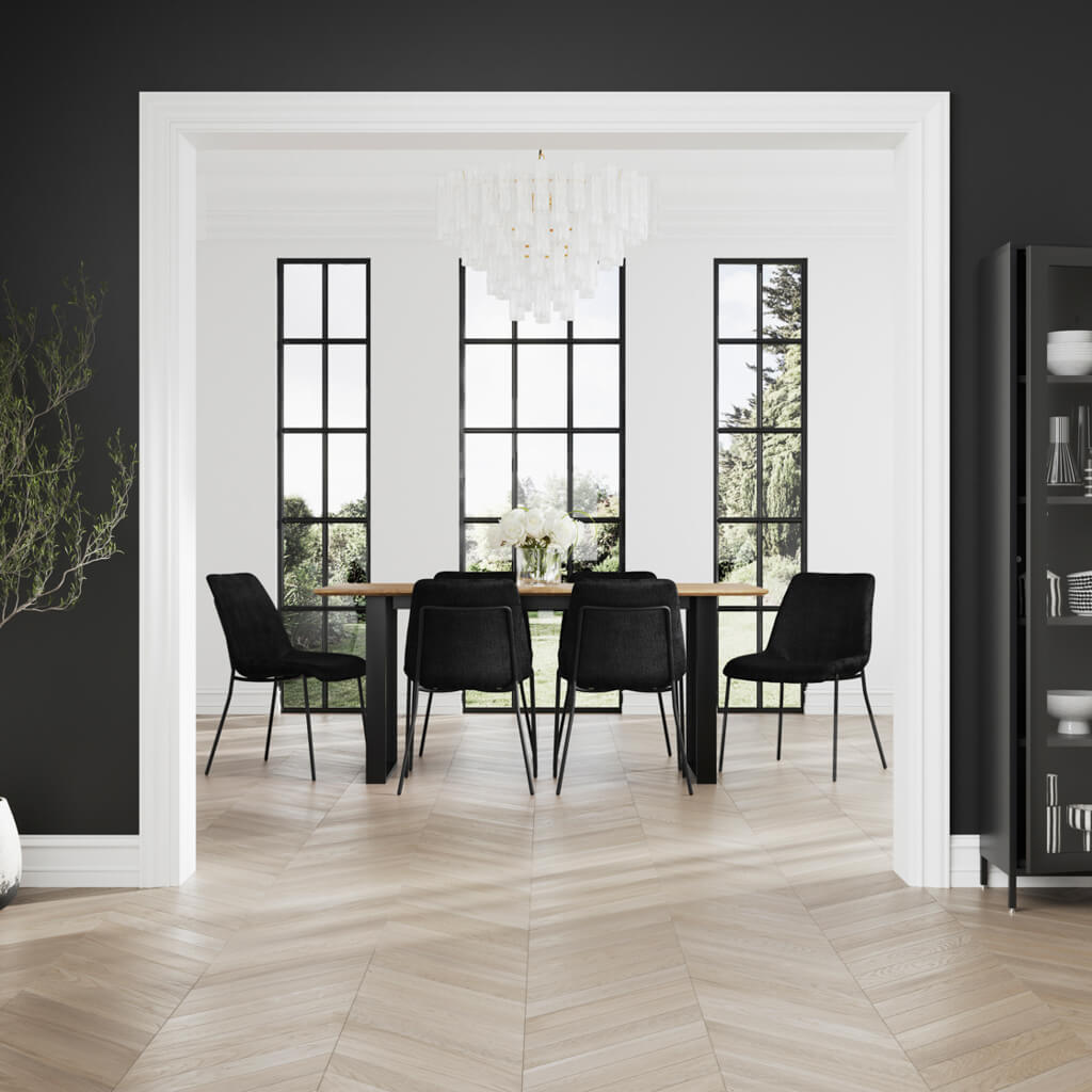 LPD Furniture Carlo black textured velvet dining chair with curved metal back in a modern dining setting