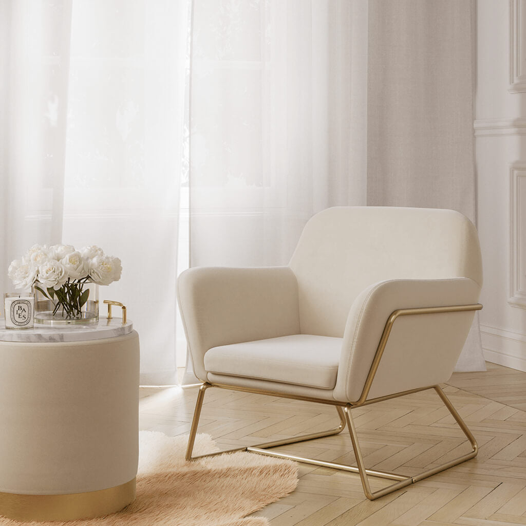 LPD Furniture Charles beige velvet armchair with brushed gold frame in a modern living room setting