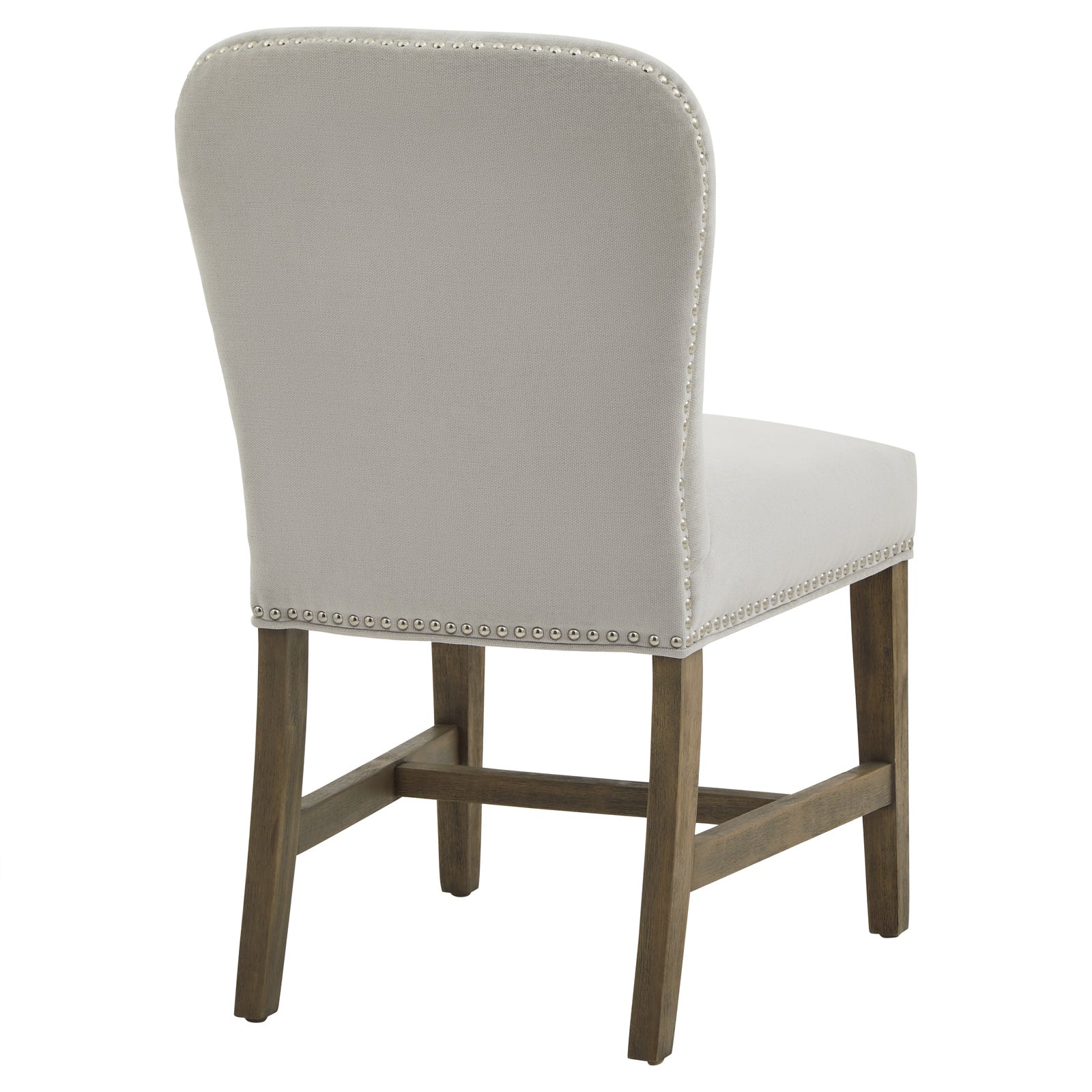 Close-up of Hill Interiors Cobham grey dining chair upholstery texture and antique brass stud detailing