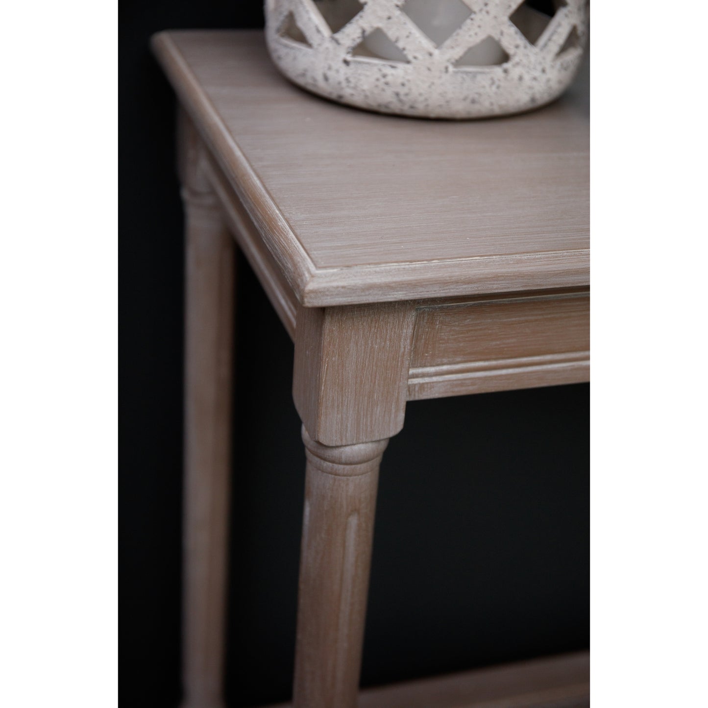 Close-up of Hill Interiors Serene Rattan Collection console table showcasing the rattan weave and wood grain