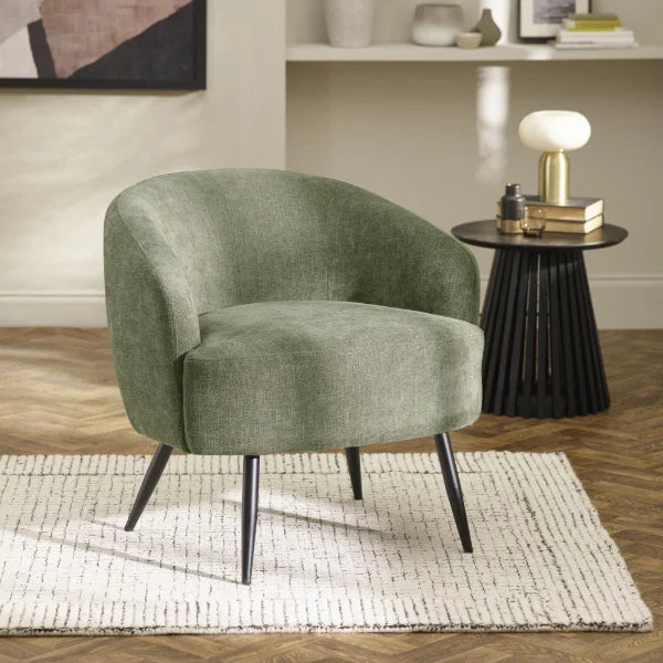 Dahlia olive green accent chair with curved backrest in a modern living room setting