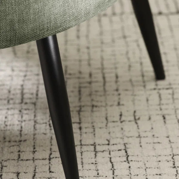Dahlia olive green accent chair with curved backrest in a modern living room setting