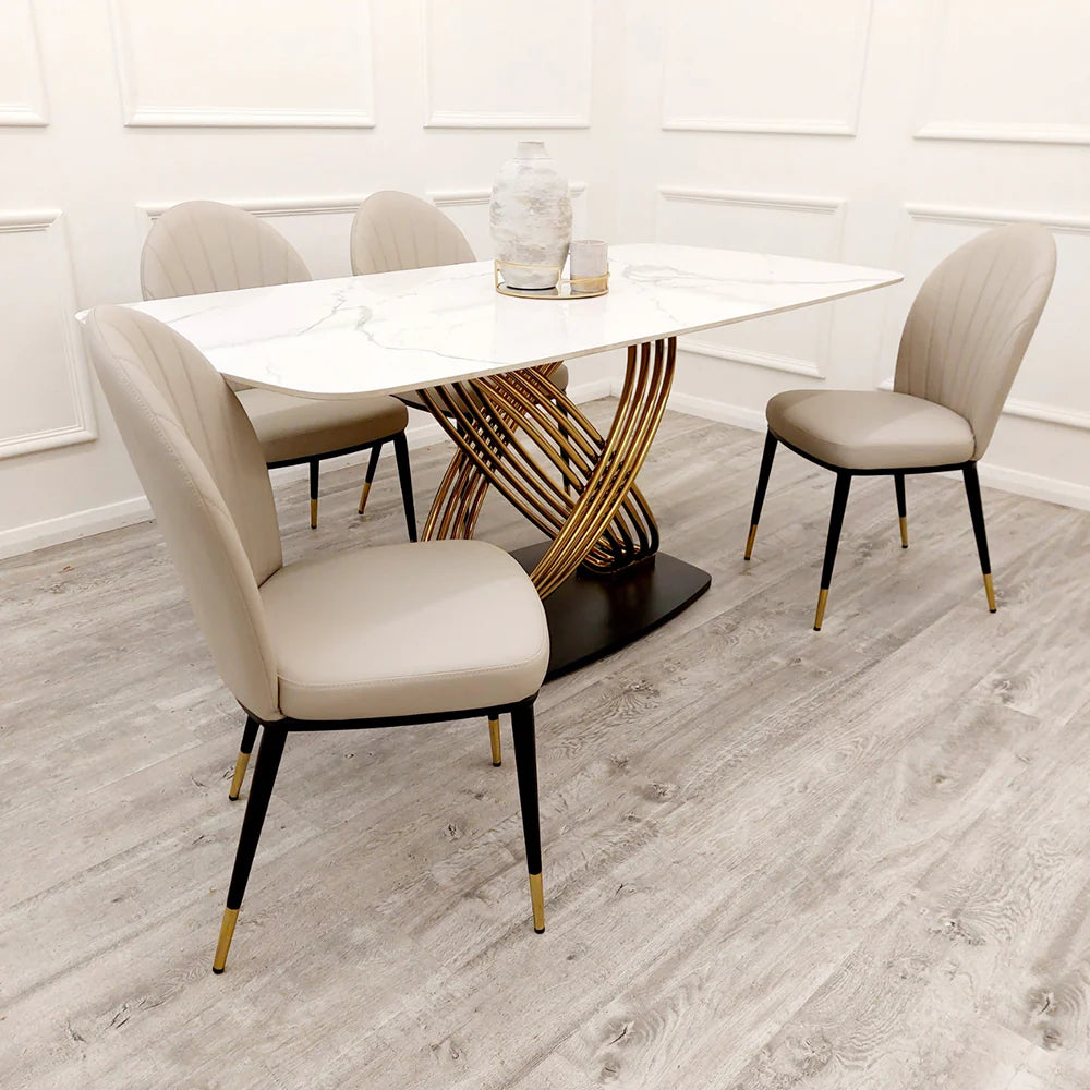 Furnish365 Etta dining chair in soft neutral fabric with curved backrest and gold-tipped legs in a contemporary dining setting