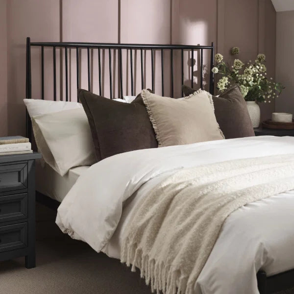 Floyd black metal spindle bed in a modern bedroom setting