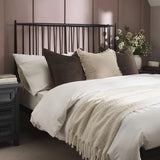 Floyd black metal spindle bed in a modern bedroom setting