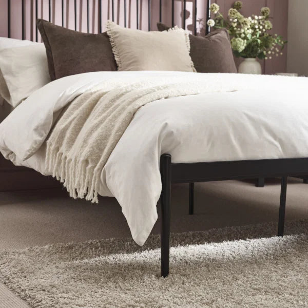 Floyd black metal spindle bed in a modern bedroom setting