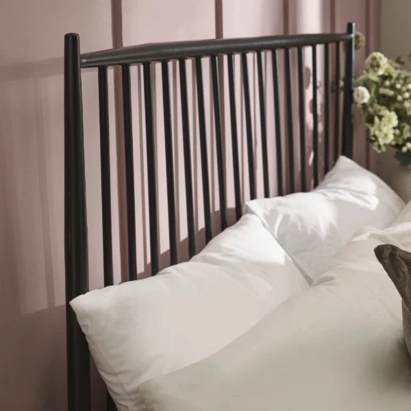 Floyd black metal spindle bed in a modern bedroom setting