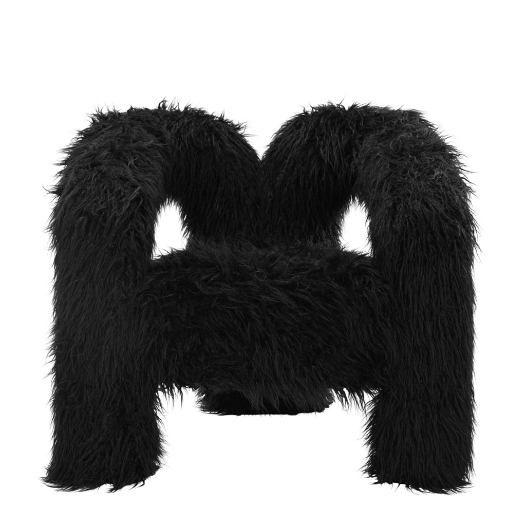 LPD Furniture Freyja jet black faux Mongolian fur extra-large accent chair with curved three-leg base in a modern living room setting