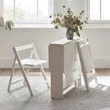 Gatan white gateleg table with 2 chairs in a compact kitchen or dining setting