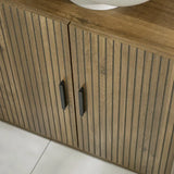 Julian Bowen Hampshire walnut under sink bathroom storage unit in a modern bathroom setting