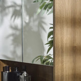 	Julian Bowen Hampshire walnut mirrored bathroom wall cabinet in a modern bathroom setting