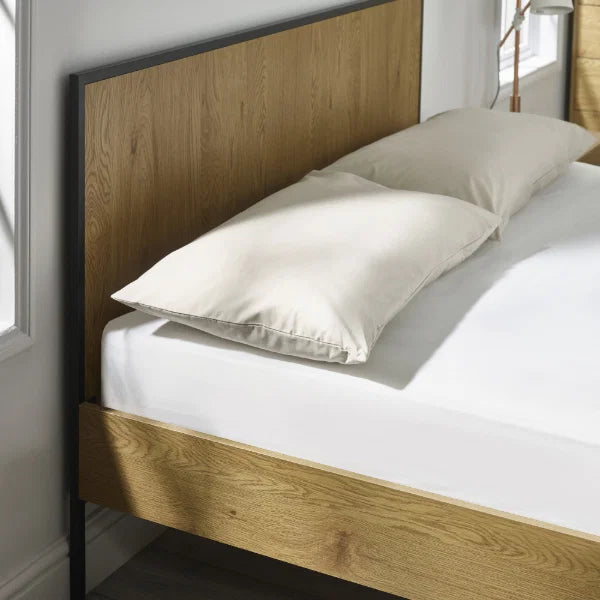 Harlow oak-effect double bed frame with black metal frame in a modern bedroom setting