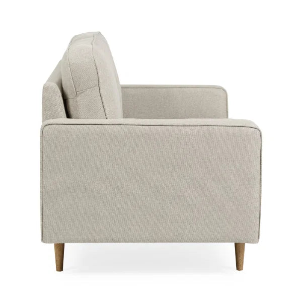 Henrietta beige 2 seater sofa with tufted seat cushions in a modern living room setting