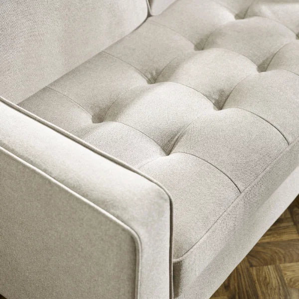 Henrietta beige 2 seater sofa with tufted seat cushions in a modern living room setting