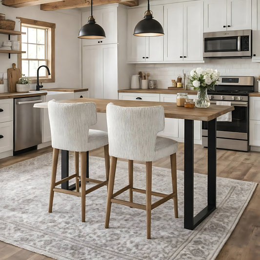 	Hill Interiors Avia mist grey fabric barstool with wooden frame, placed in a modern kitchen setting