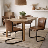 Hill Interiors Billy curved caramel leather dining chair with black metal frame and elegant curved silhouette, placed in a modern dining setting