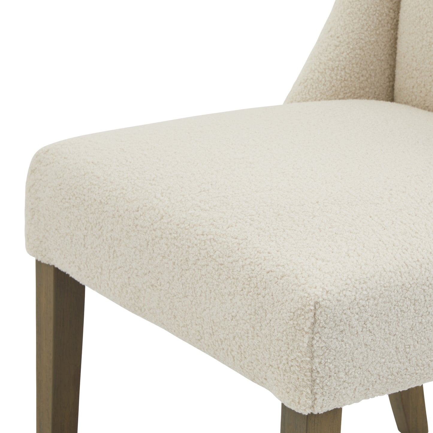 	Hill Interiors Compton boucle dining chair showing the rubberwood leg frame and sturdy construction