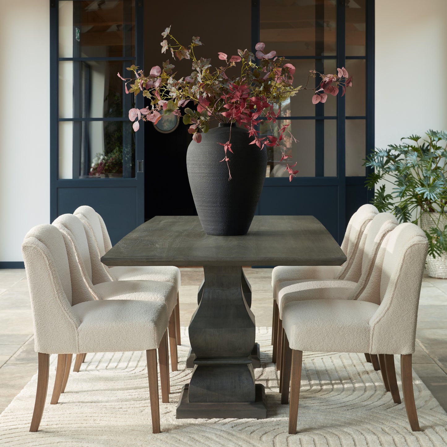 Hill Interiors Compton boucle dining chair styled with minimalist tableware on a modern dining table