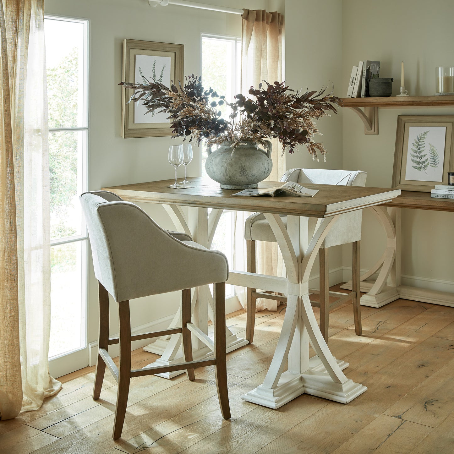 	Hill Interiors Epsom grey fabric barstool with wooden frame, placed in a modern kitchen setting