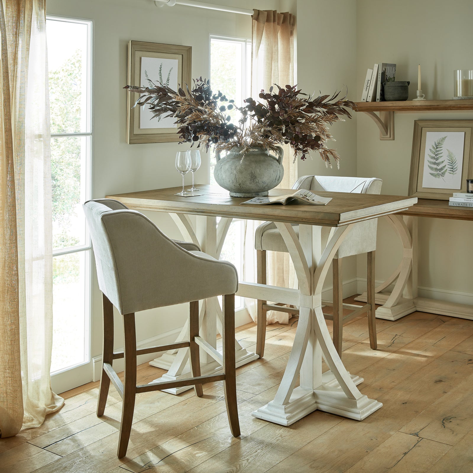 	Hill Interiors Epsom grey fabric barstool with wooden frame, placed in a modern kitchen setting