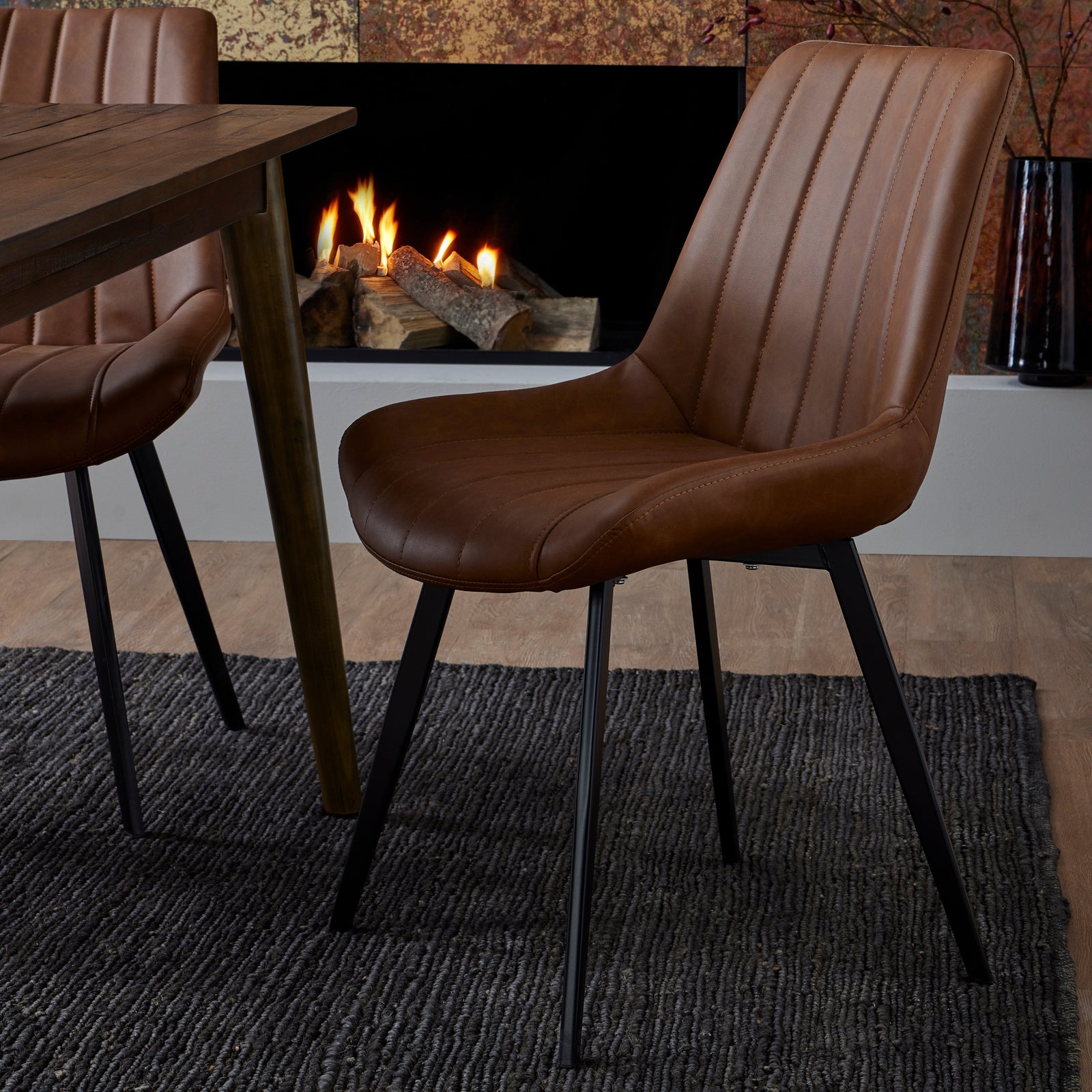 Hill Interiors Malmo tan dining chair in a dining room setting with wooden table and natural lighting