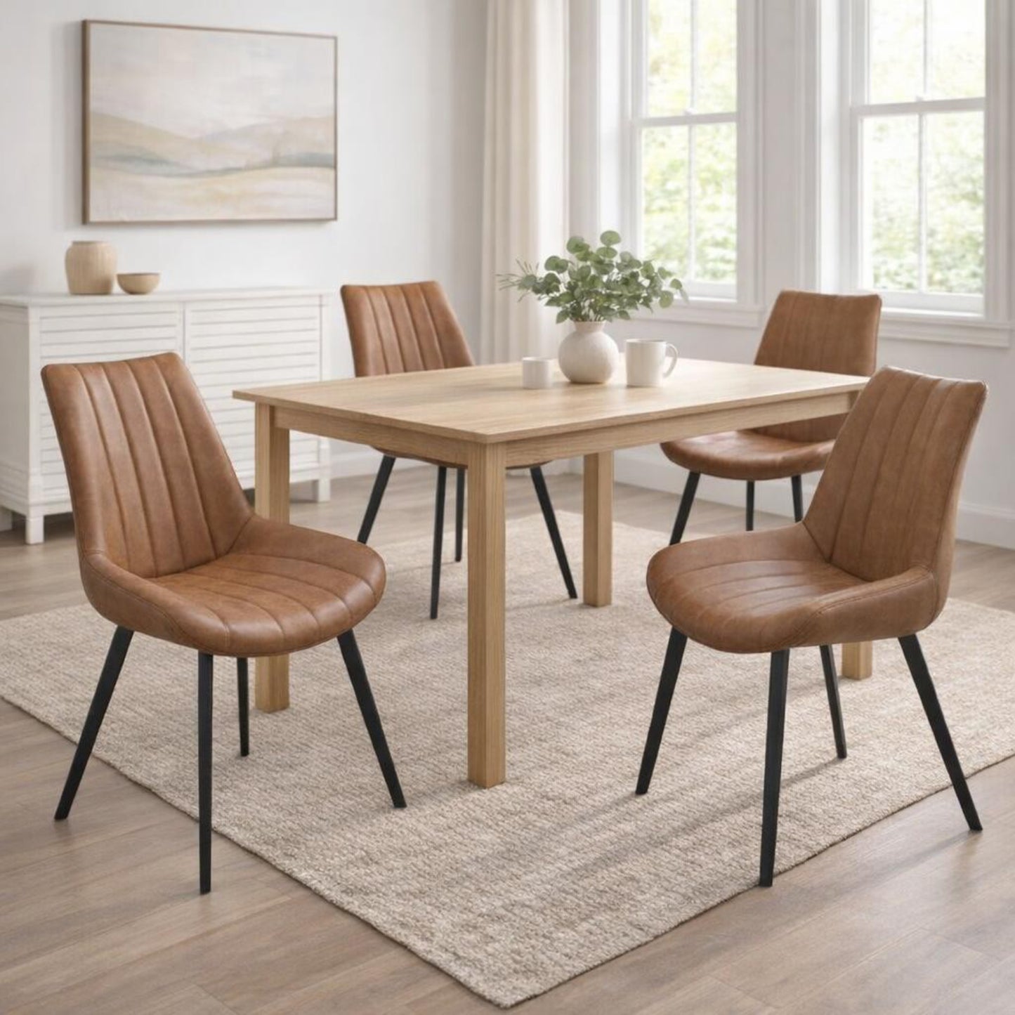 Hill Interiors Malmo tan dining chair with channel-stitched backrest and black metal legs, placed in a modern dining setting