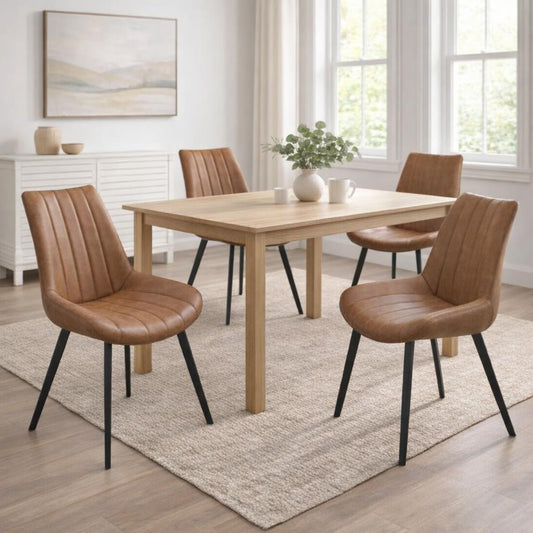 Hill Interiors Malmo tan dining chair with channel-stitched backrest and black metal legs, placed in a modern dining setting