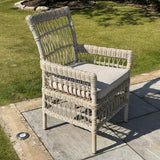 Hill Interiors Provence Collection beige outdoor dining chair in a modern garden setting