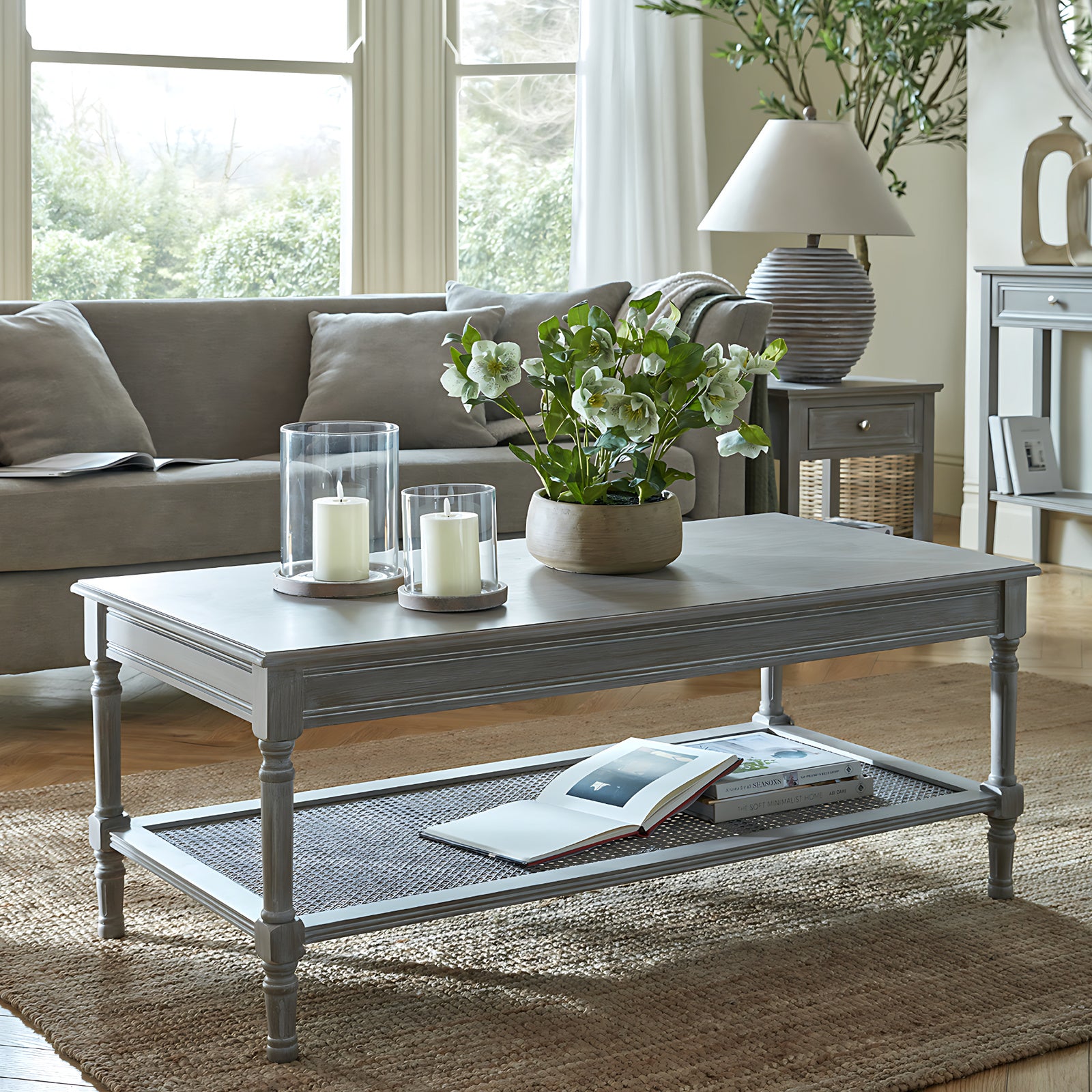 Hill Interiors Serene Rattan Collection coffee table with rattan and wood design, placed in a modern living room setting
