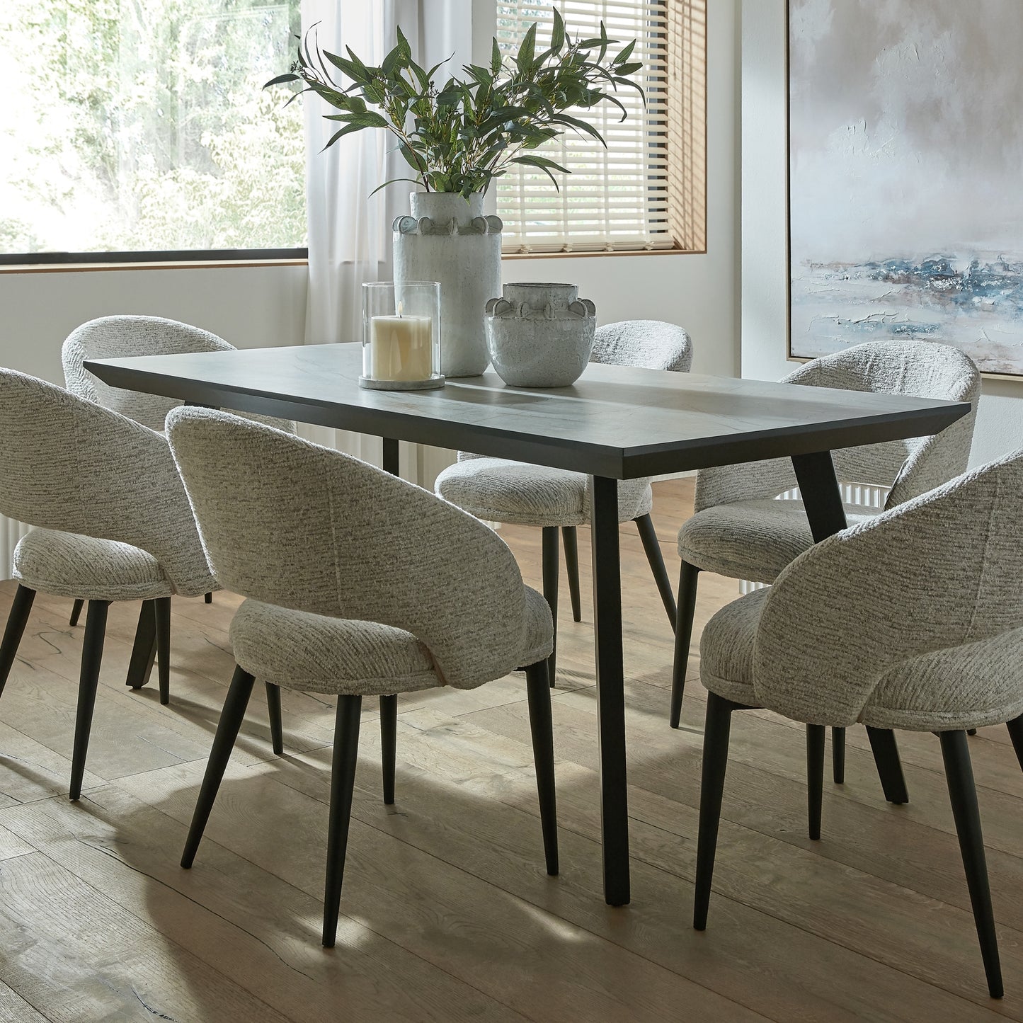 	Hill Interiors Sorelle curved white dining chair showing the metal leg frame and sturdy construction