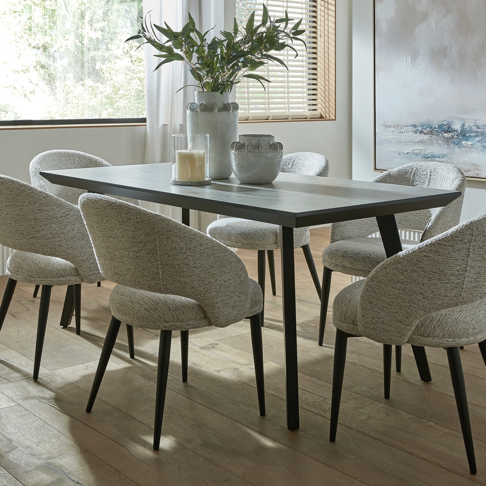	Hill Interiors Sorelle curved white dining chair showing the metal leg frame and sturdy construction