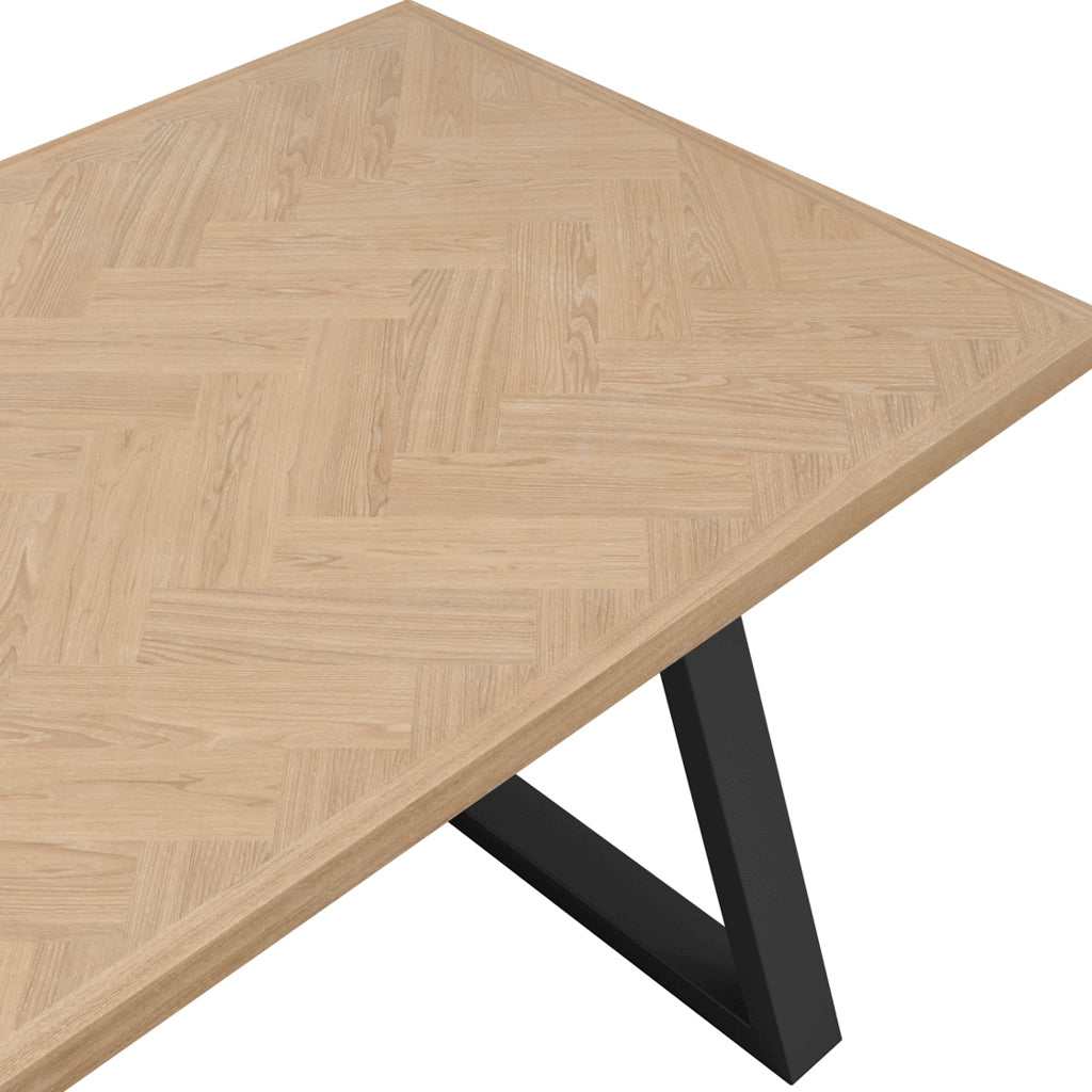 LPD Furniture Hyde natural wood herringbone dining table with black metal legs in a modern dining setting